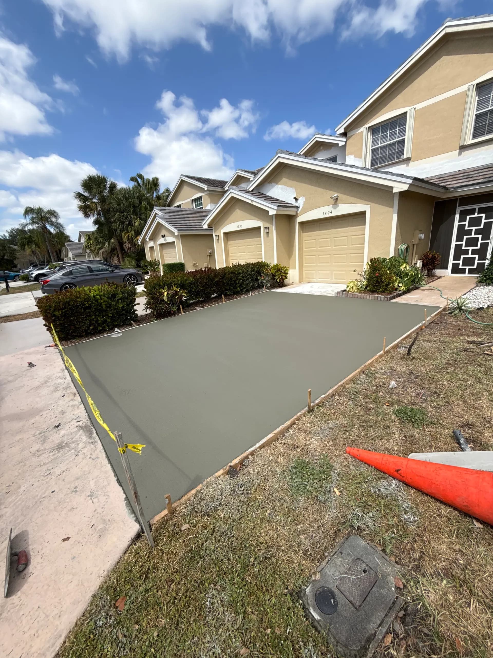 Well-maintained concrete driveway in South Florida residential neighborhood