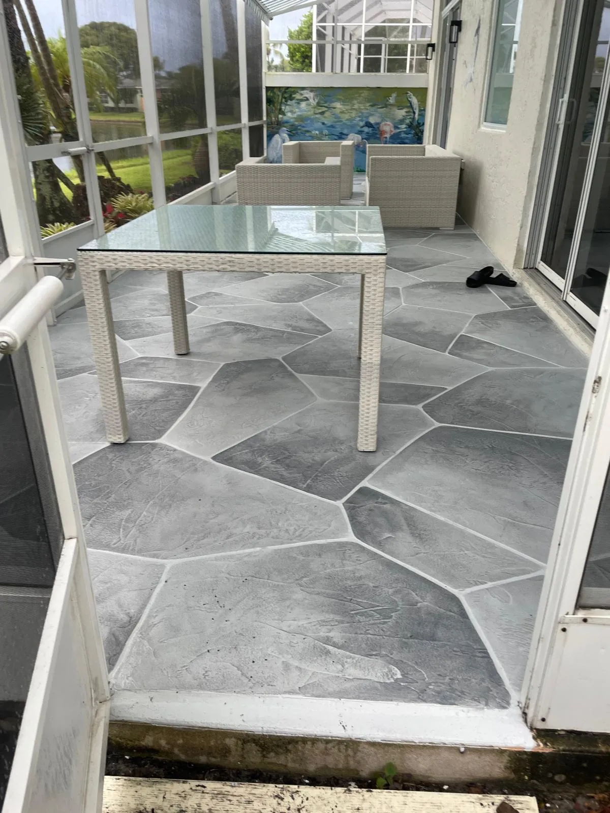 Decorative stamped concrete patio with outdoor furniture in South Florida