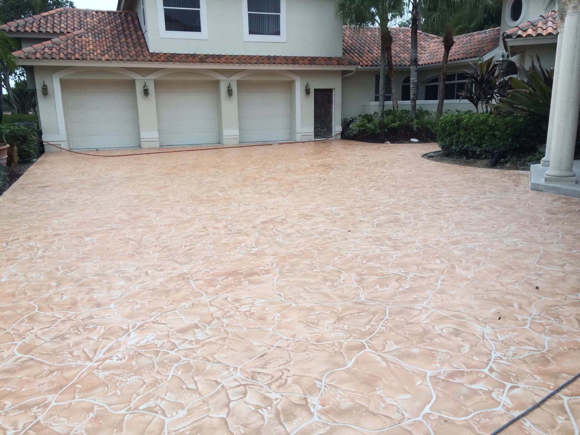 Stamped concrete driveway with warm earth tones