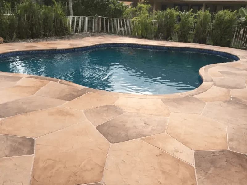 Professional concrete sealer application on decorative patio